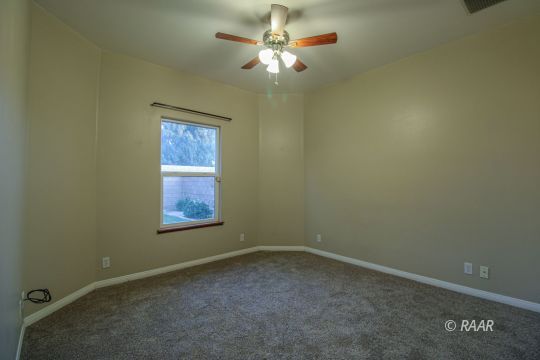 428 Abigail Street Ridgecrest, CA 93555 - Photo 21 of 34 an empty room with windows and fan