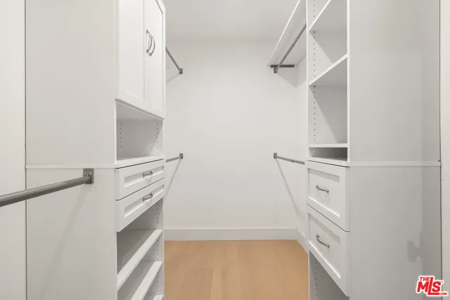 a view of walk in closet with empty racks