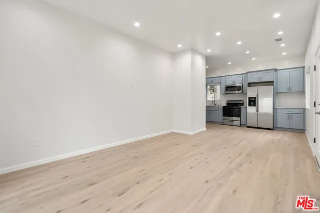 a kitchen with stainless steel appliances a refrigerator sink and cabinets