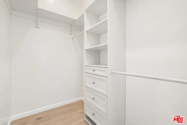 a bathroom with a toilet a sink a mirror and shower