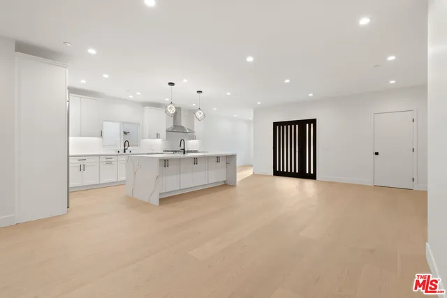 a view of a kitchen with white cabinets