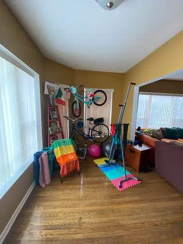 a room with toys and white walls with wooden floor