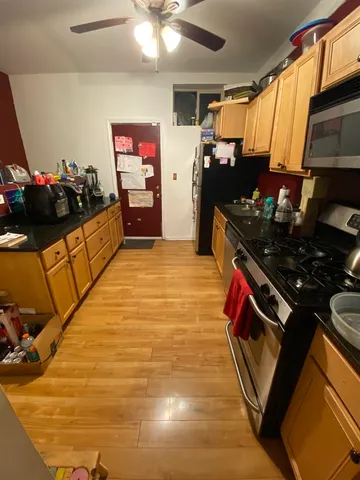 a kitchen with stainless steel appliances granite countertop a stove and a refrigerator