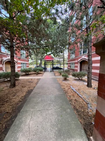 a street sign on a sidewalk next to a road