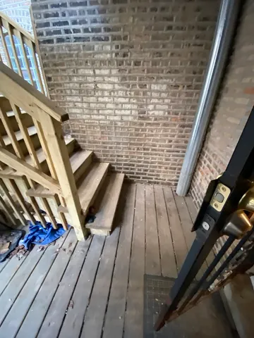 a view of a balcony with wooden floor