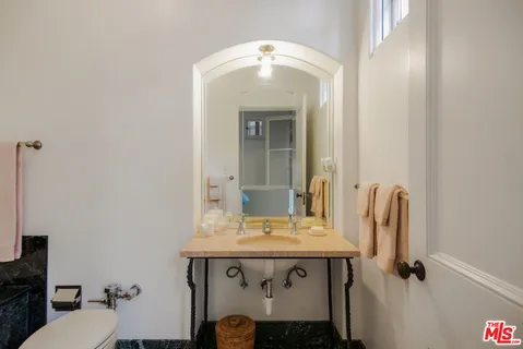 a bathroom with a tub sink and mirror
