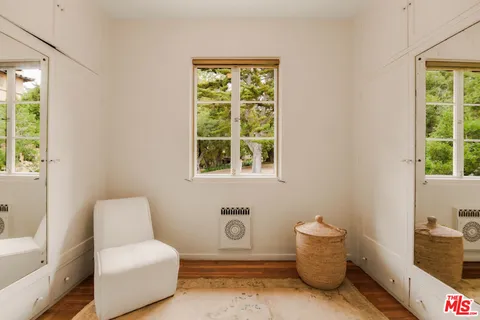 a living room with furniture gym equipment and a large window