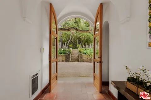 a living room with furniture and large windows