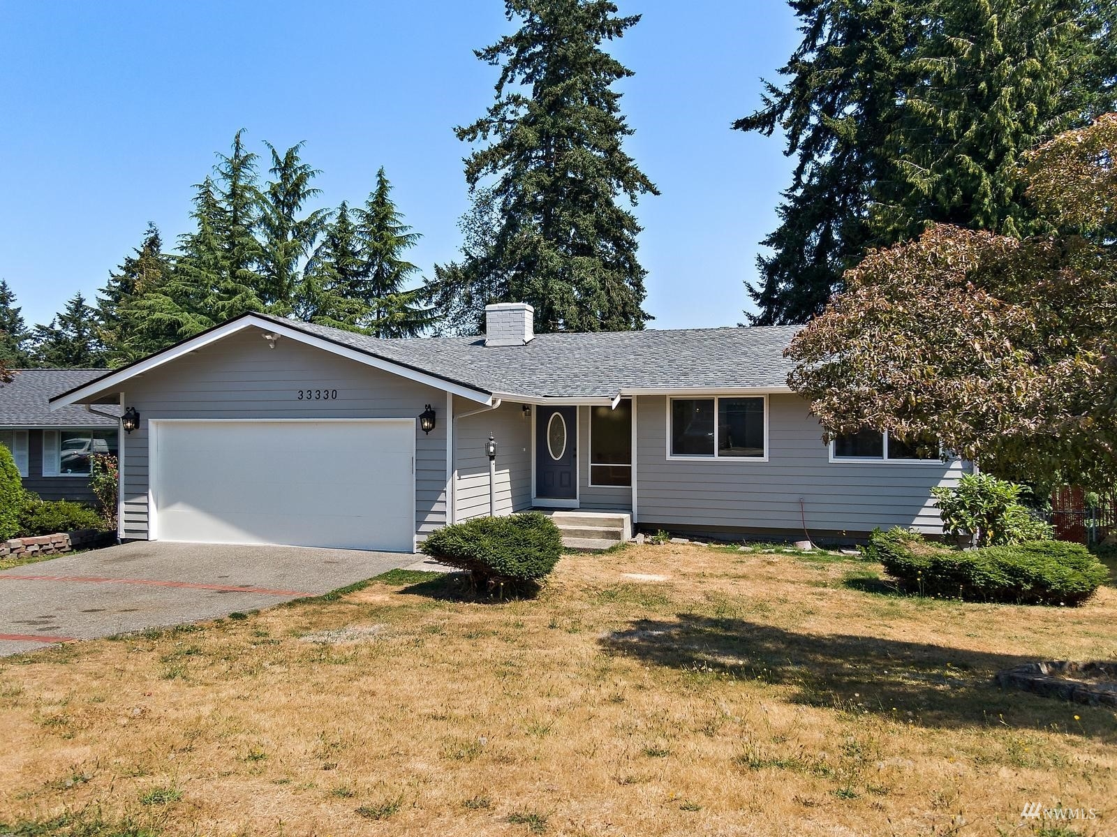 a view of a house with a yard covered in snow