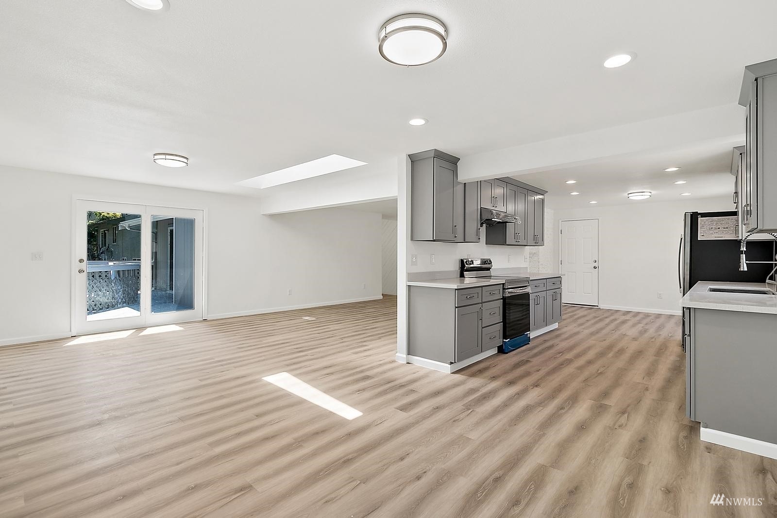 33330 29th Place Southwest Federal Way, WA 98023 - Photo 12 of 37 a kitchen with stainless steel appliances granite countertop a sink and stove top oven with wooden floor