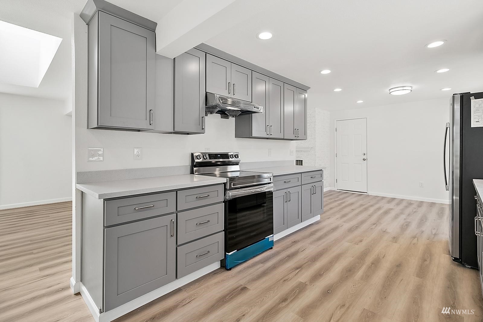33330 29th Place Southwest Federal Way, WA 98023 - Photo 14 of 37 a kitchen with white cabinets stainless steel appliances and sink