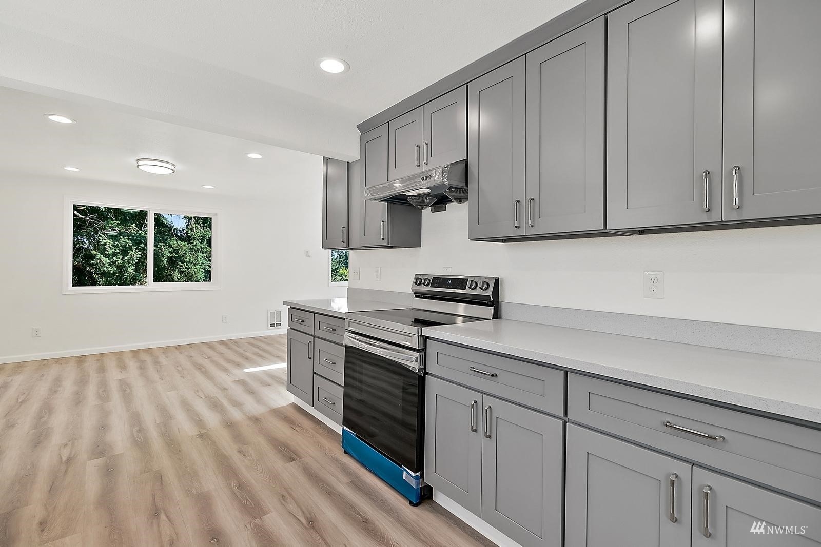 33330 29th Place Southwest Federal Way, WA 98023 - Photo 16 of 37 a kitchen with stainless steel appliances granite countertop a sink dishwasher a stove and a refrigerator with wooden floor