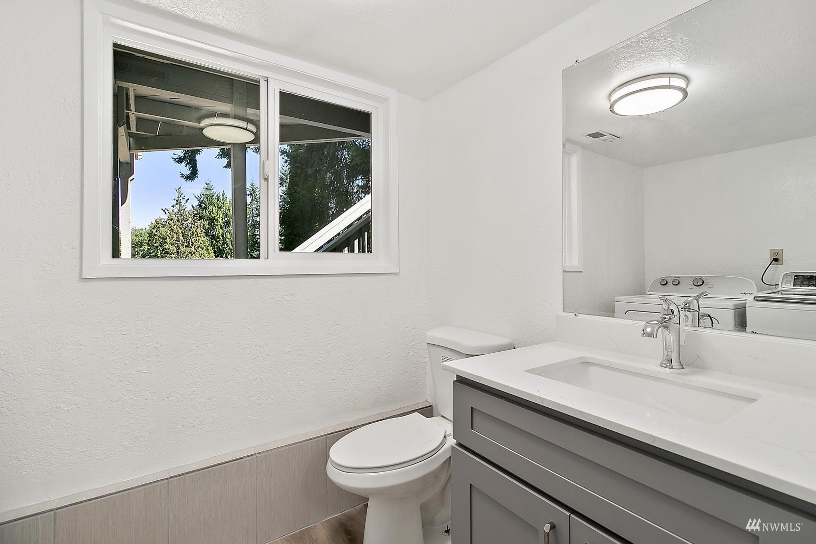 33330 29th Place Southwest Federal Way, WA 98023 - Photo 31 of 37 a bathroom with a sink a toilet and a mirror