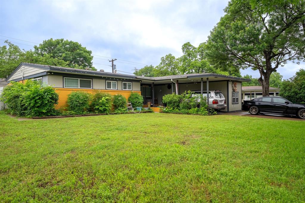 Ranch-style home with a front yard and brick siding