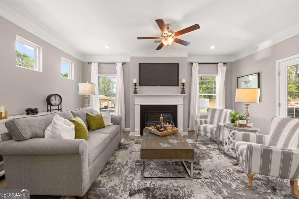 1416 Trellis Court, Unit (LOT 21) Hampton, GA 30228 - Photo 9 of 27 a living room with furniture and a fireplace