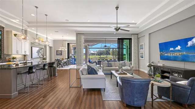 a view of a patio with couches table and chairs under an umbrella