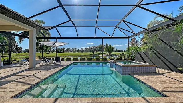 a living room with furniture a ceiling fan and a large window