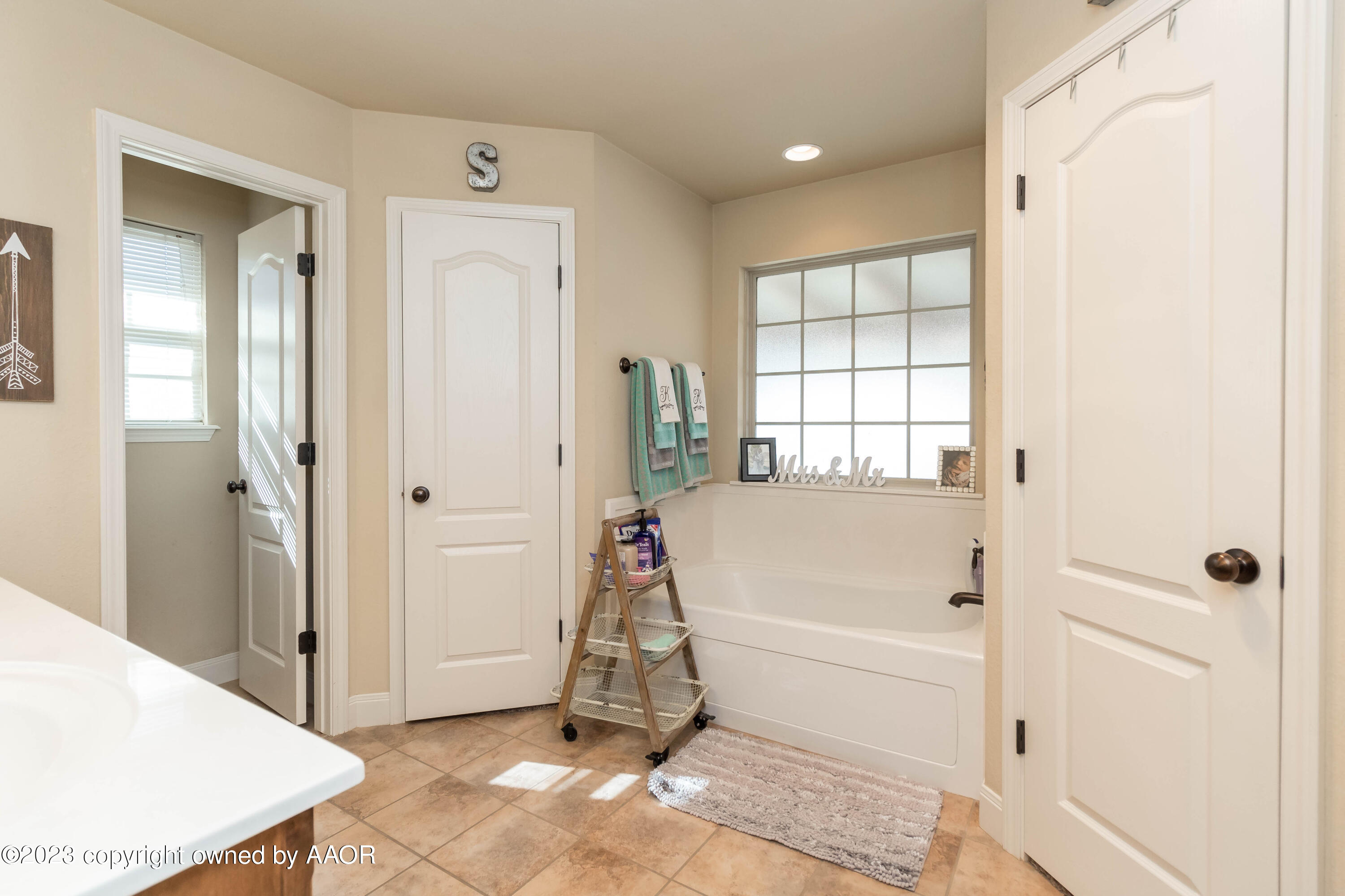 5802 South Rusk Street Amarillo, TX 79118 - Photo 12 of 17 a view of a bathroom with tub and windows