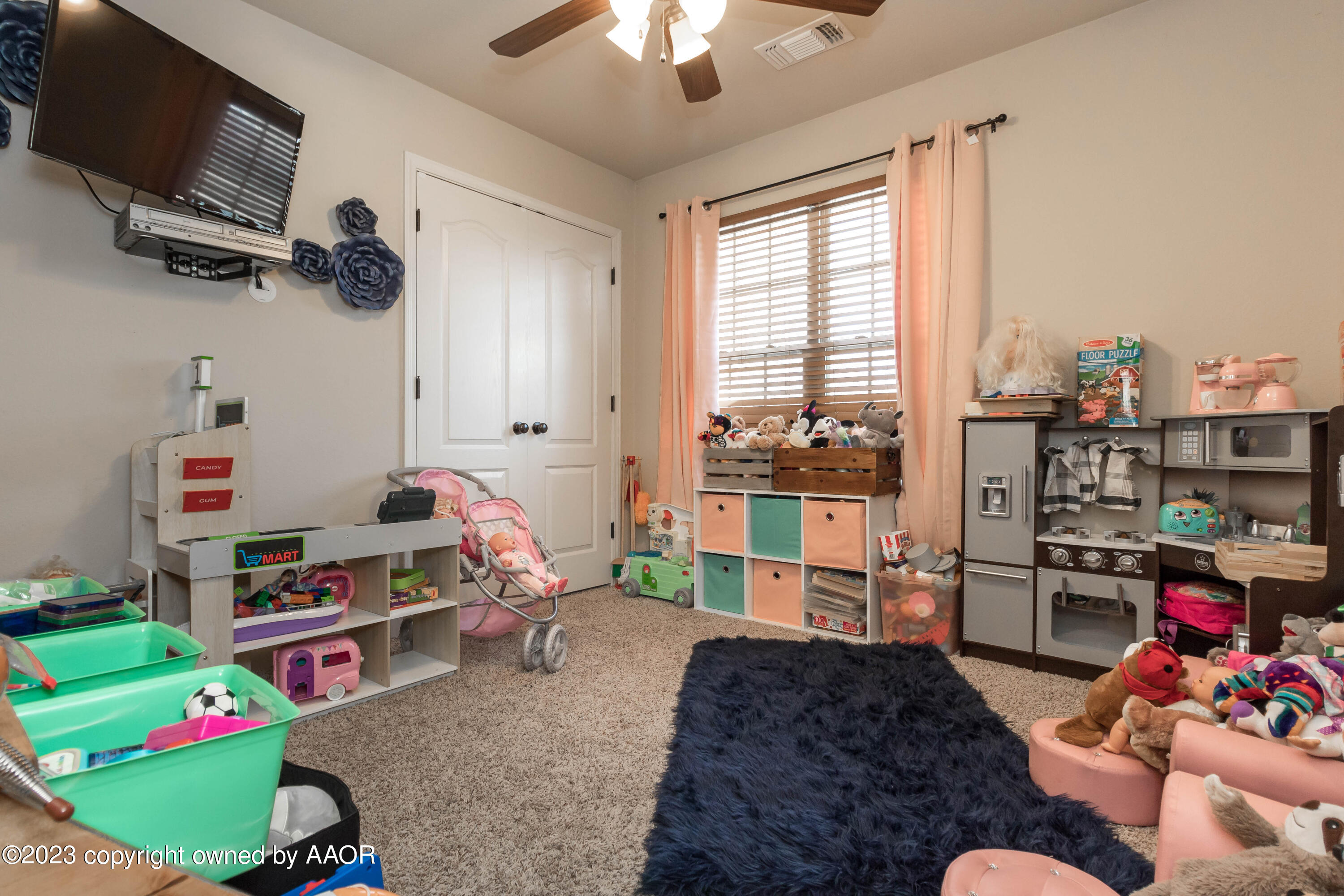 5802 South Rusk Street Amarillo, TX 79118 - Photo 14 of 17 a bedroom with furniture and a flat screen tv