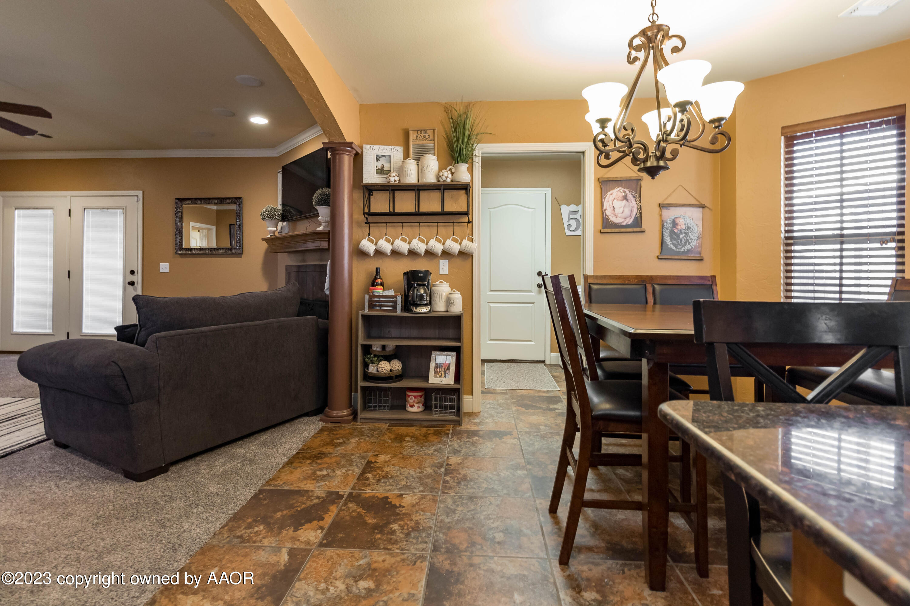 5802 South Rusk Street Amarillo, TX 79118 - Photo 7 of 17 a living room with furniture a chandelier and a dining table