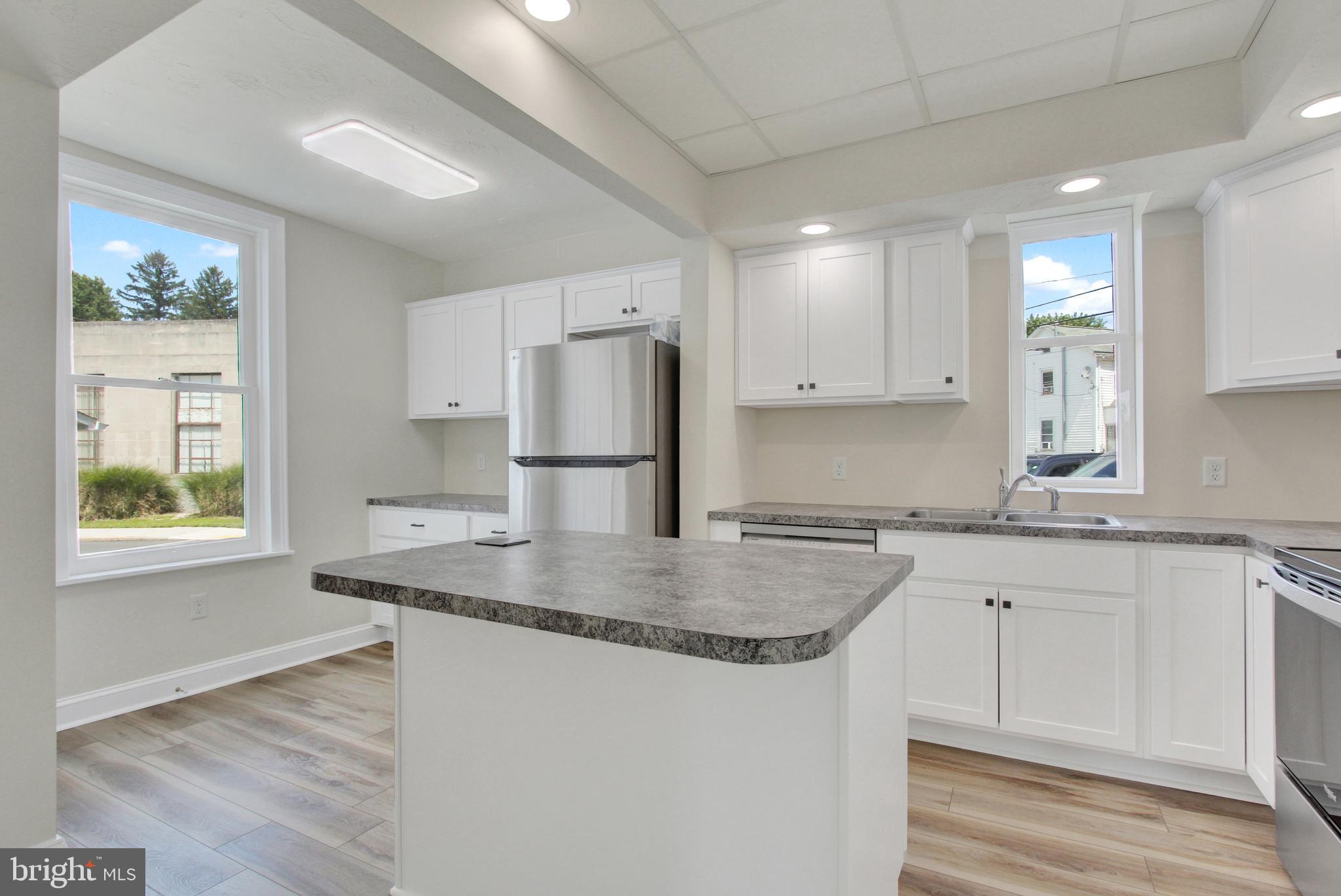 103 Rampike Hill Road Bendersville, PA 17304 - Photo 8 of 22 a kitchen with kitchen island granite countertop a sink cabinets and refrigerator