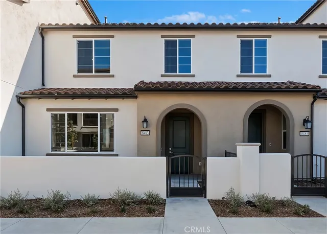 a front view of a house with plants
