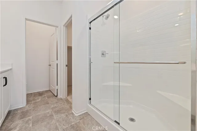 a bathroom with a glass shower door