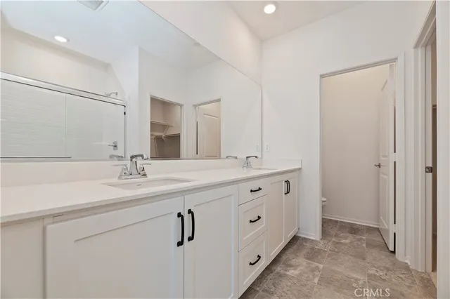 a bathroom with a double vanity sink and mirror