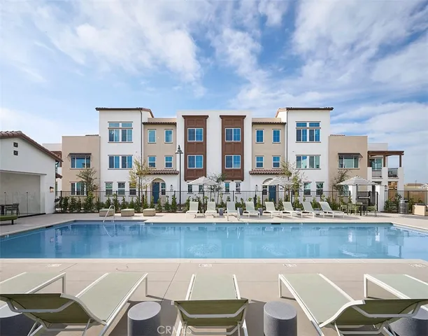 a view of a building with swimming pool and sitting area