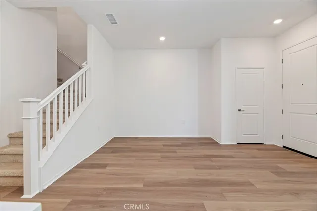 a view of an entryway with wooden floor