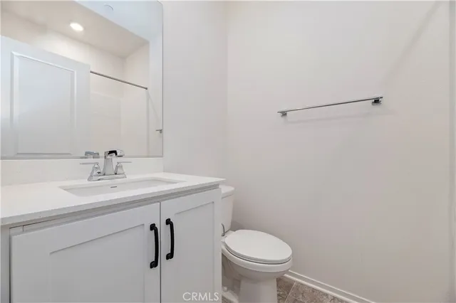 a bathroom with a sink toilet and a mirror
