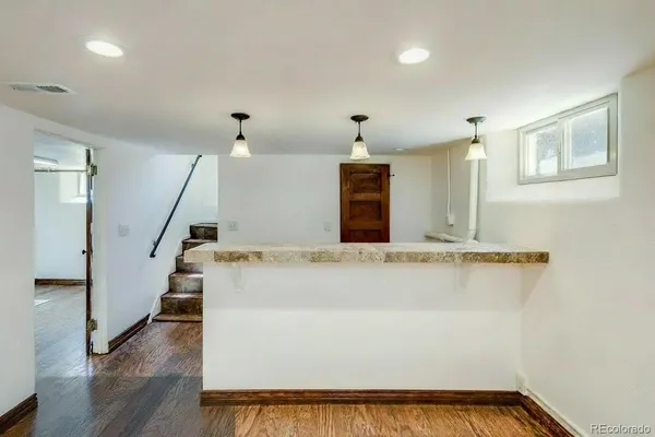 a view of a room with wooden floor and staircase