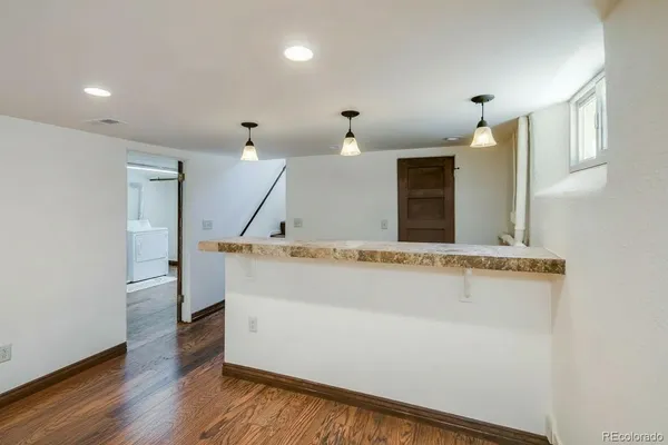 a view of room with wooden floor and window