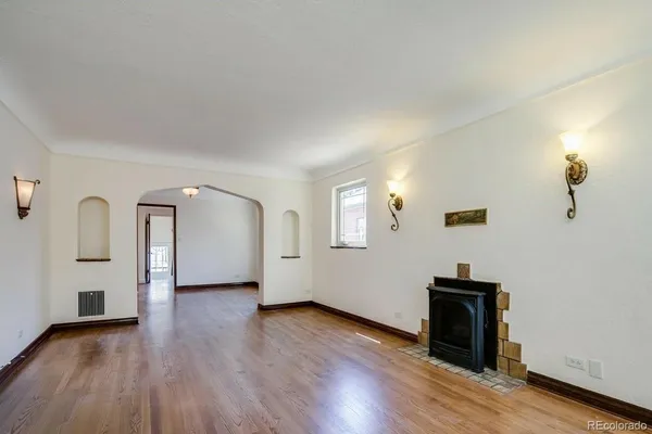 a view of a room with wooden floor and window