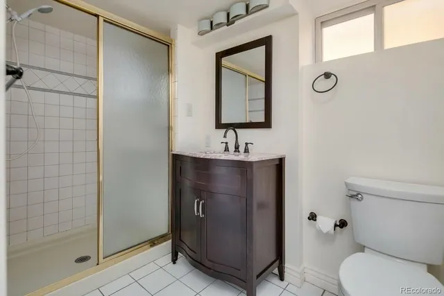 a bathroom with a toilet sink and shower