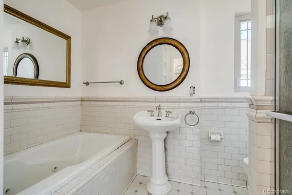 a bathroom with a sink a bathtub and a mirror