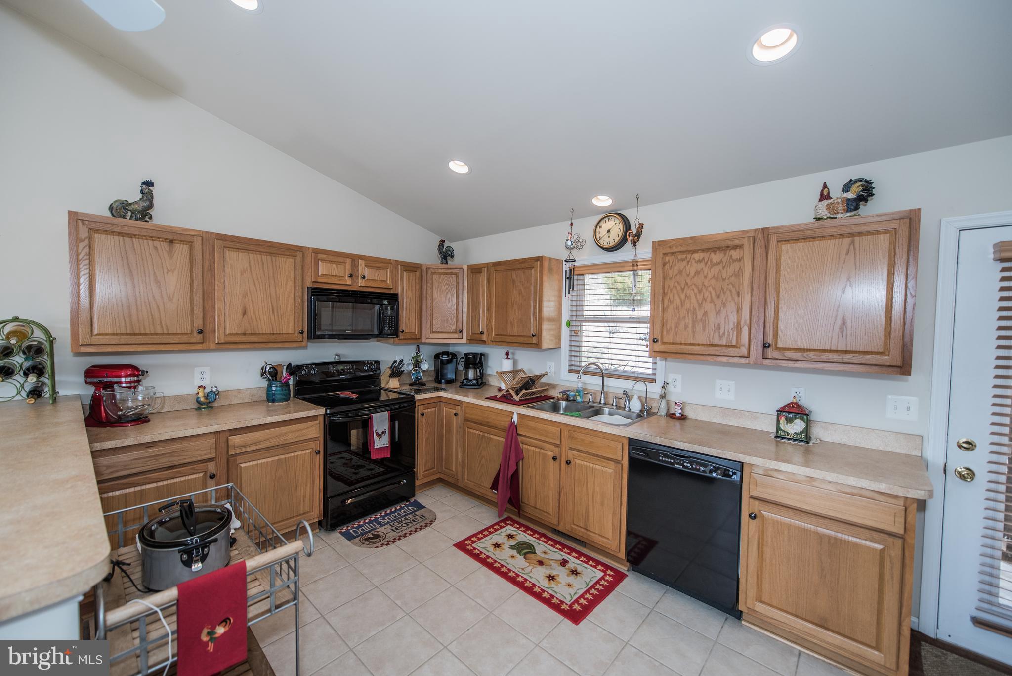 964 Granny Smith Road Linden, VA 22642 - Photo 15 of 30 a kitchen with a sink stove and wooden cabinets