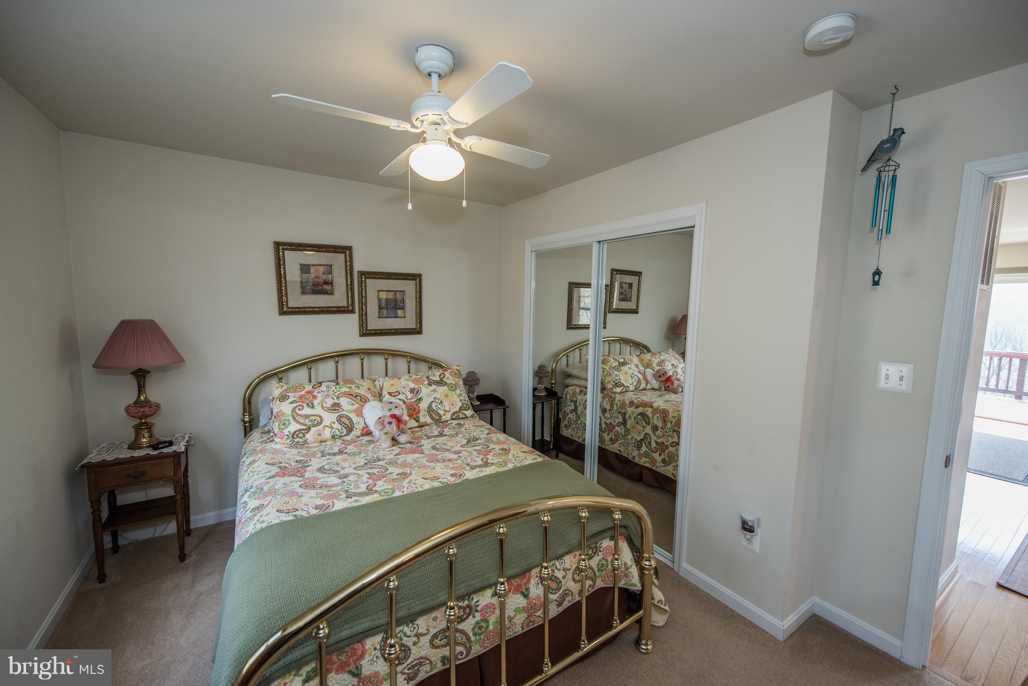 964 Granny Smith Road Linden, VA 22642 - Photo 18 of 30 a bedroom with a bed and a chandelier
