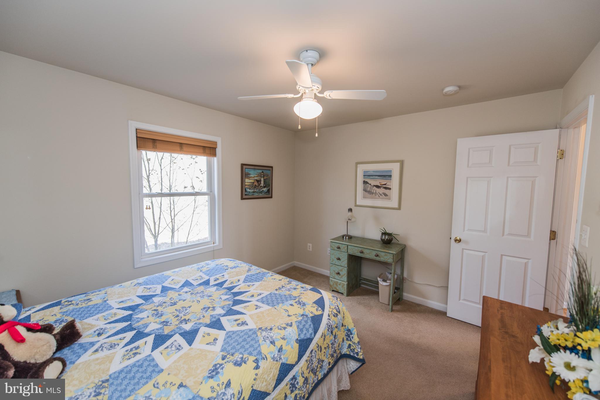 964 Granny Smith Road Linden, VA 22642 - Photo 22 of 30 a bedroom with a bed and a chandelier