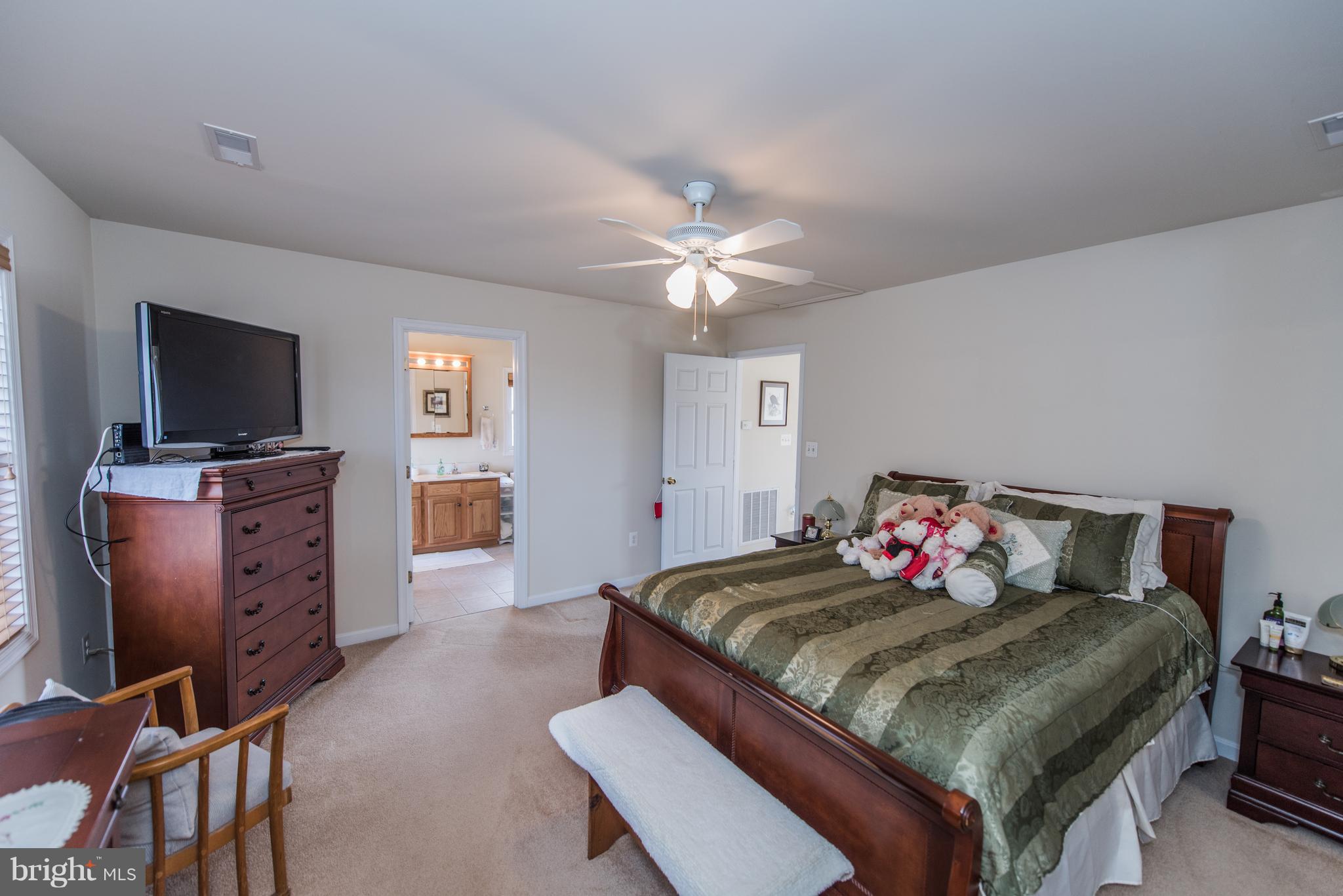 964 Granny Smith Road Linden, VA 22642 - Photo 25 of 30 a bedroom with a bed and a flat screen tv