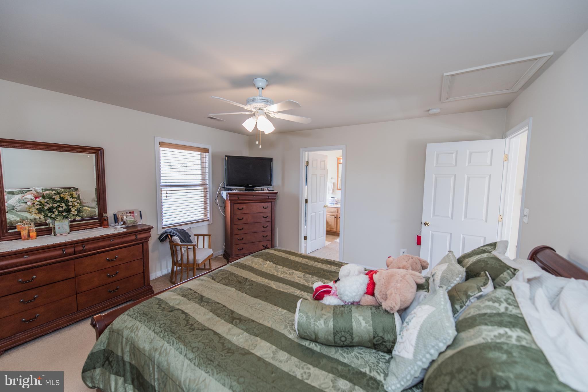 964 Granny Smith Road Linden, VA 22642 - Photo 26 of 30 a bedroom with a bed and a chandelier