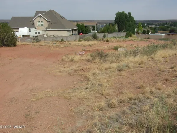 a view of a dirt road with a building