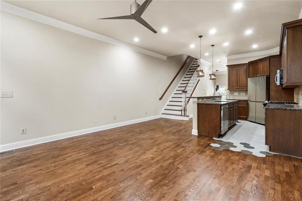 2663 Rivers Edge Drive Northeast Brookhaven, GA 30324 - Photo 13 of 37 an empty room with wooden floor staircase and windows
