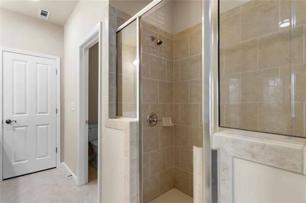 2663 Rivers Edge Drive Northeast Brookhaven, GA 30324 - Photo 23 of 37 a bathroom with a shower and a glass door