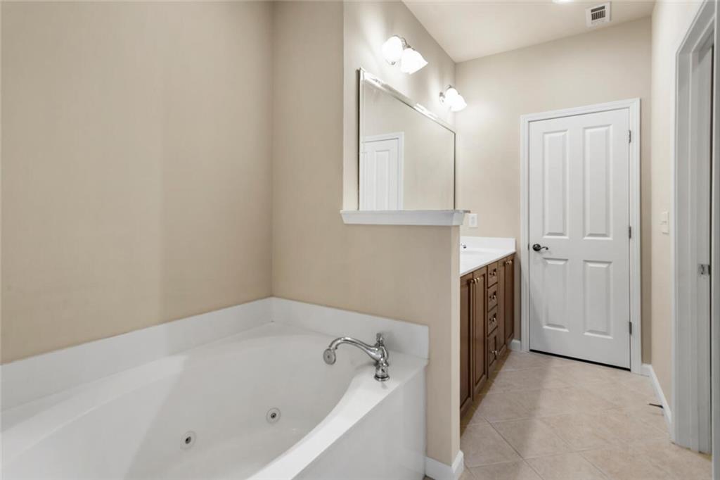 2663 Rivers Edge Drive Northeast Brookhaven, GA 30324 - Photo 24 of 37 a bathroom with a tub sink and mirror