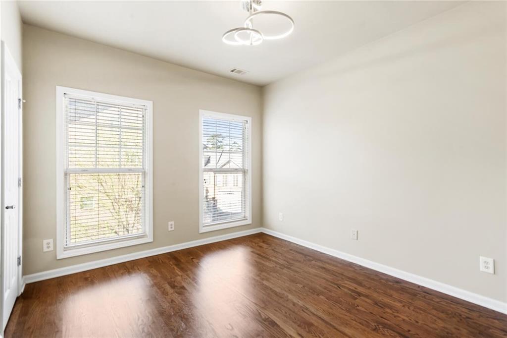 2663 Rivers Edge Drive Northeast Brookhaven, GA 30324 - Photo 27 of 37 an empty room with wooden floor and windows