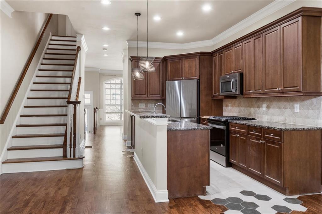 2663 Rivers Edge Drive Northeast Brookhaven, GA 30324 - Photo 9 of 37 a kitchen with granite countertop stainless steel appliances and wooden cabinets
