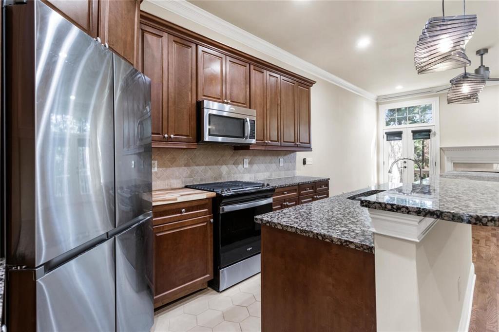 2663 Rivers Edge Drive Northeast Brookhaven, GA 30324 - Photo 10 of 37 a kitchen with granite countertop stainless steel appliances a stove microwave and sink