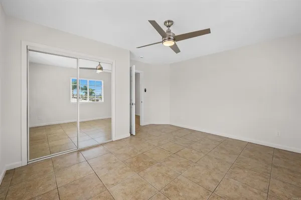an empty room with closet and windows