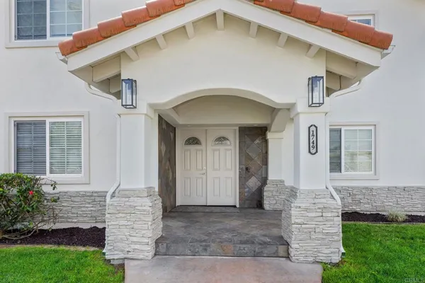 a front view of a house with garden